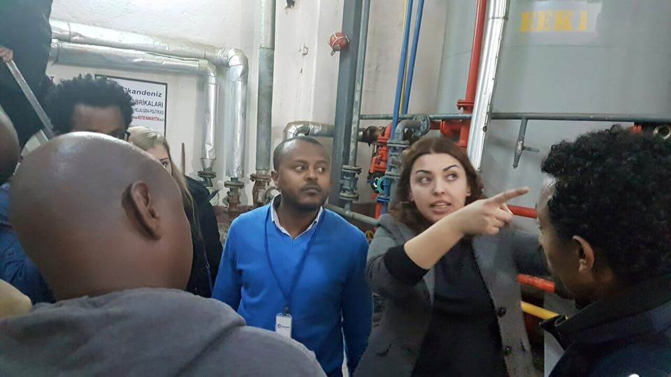 Modern exhibition hall with booths and large display banners at trade show