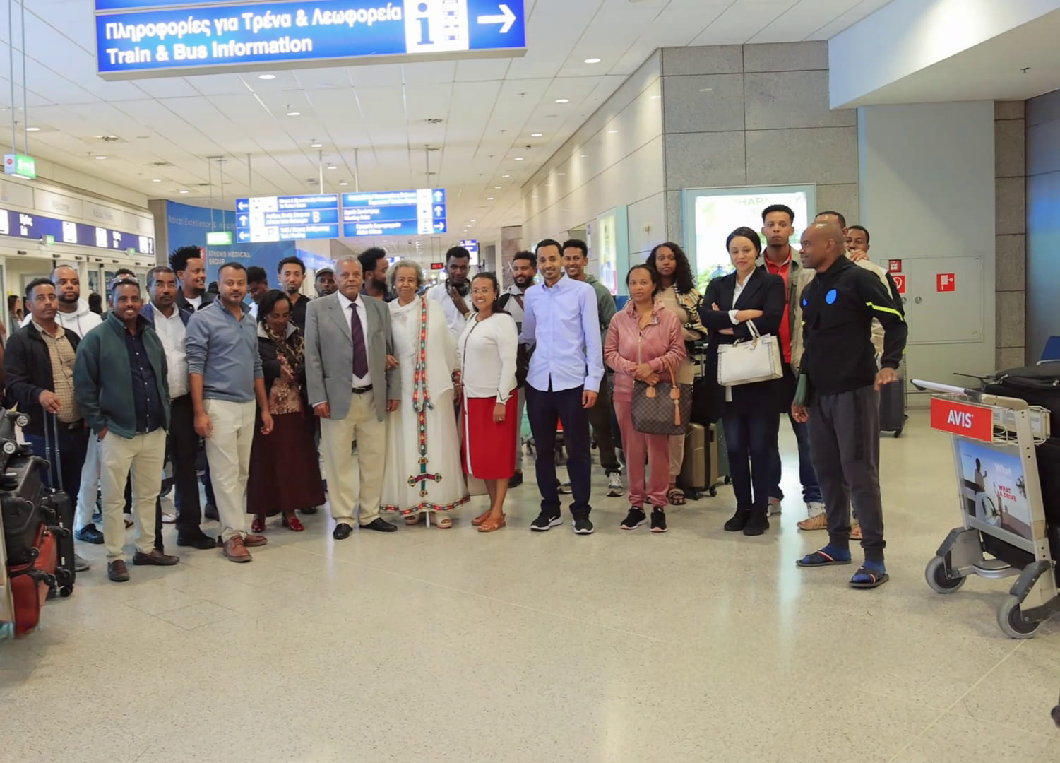 Professionals attending a large, well-lit conference with screens in Ethiopia
